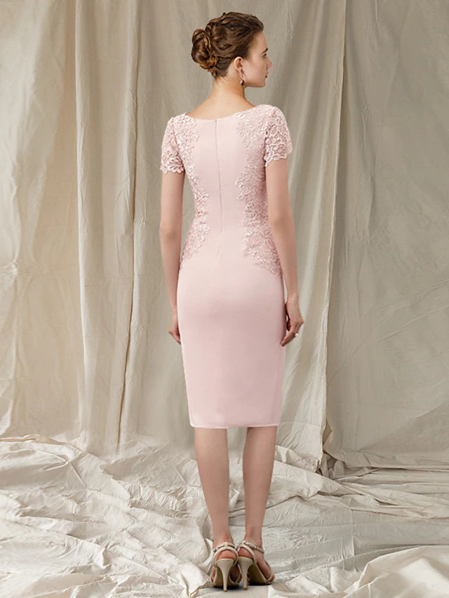 Close-up of delicate lace and applique details on a formal dress.