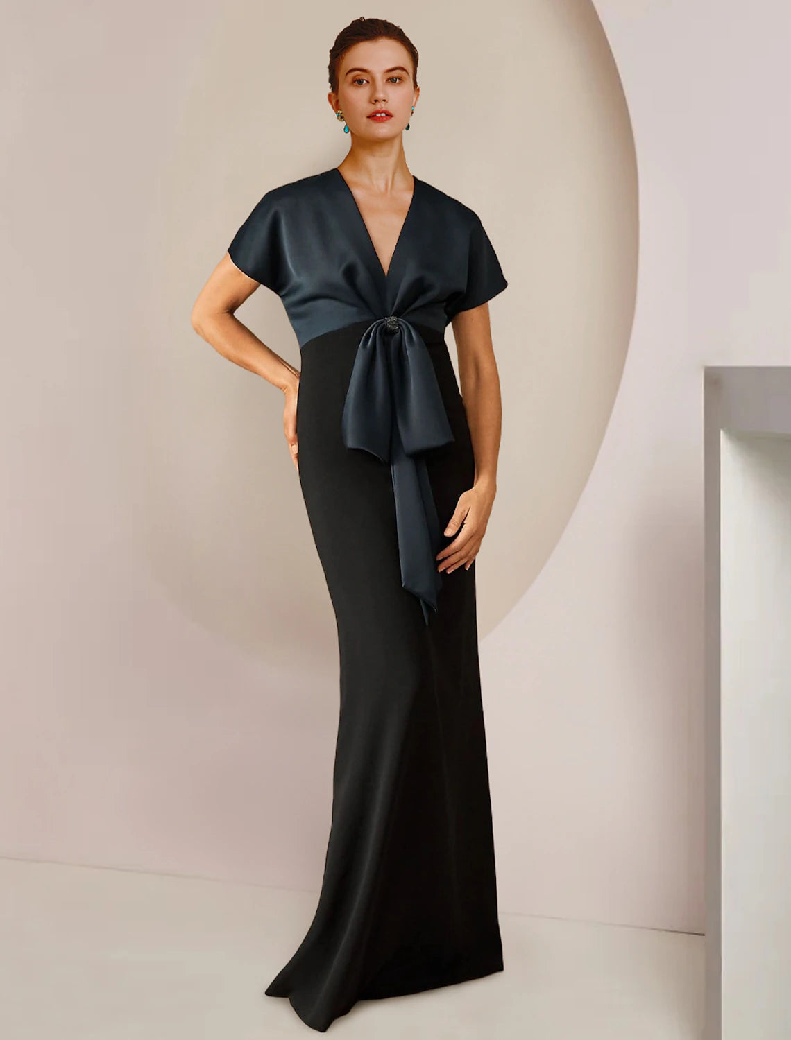 Elegant satin sheath mother of the bride dress with jewel neck and short sleeves.