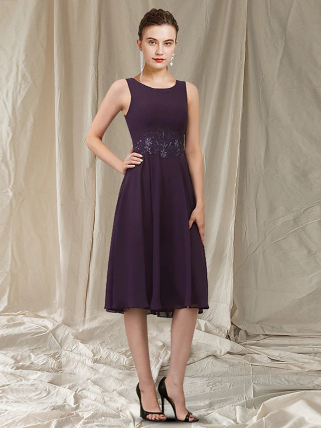Close-up of the lace appliques and jewel neckline on the dress.