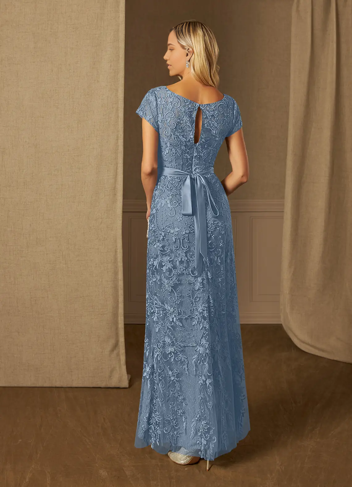 Back view of the dusty blue sheath dress featuring short sleeves and scoop neck.