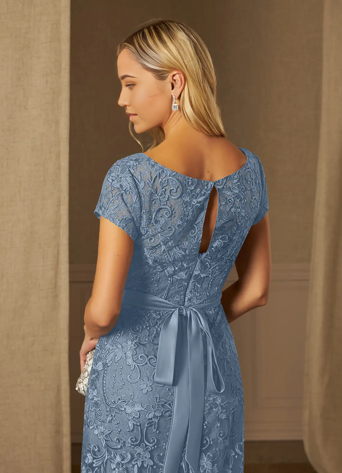 Side profile of the elegant dusty blue mother of the bride gown.