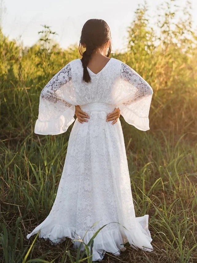 Back view of the floor length ivory flower girl dress with a simple design.