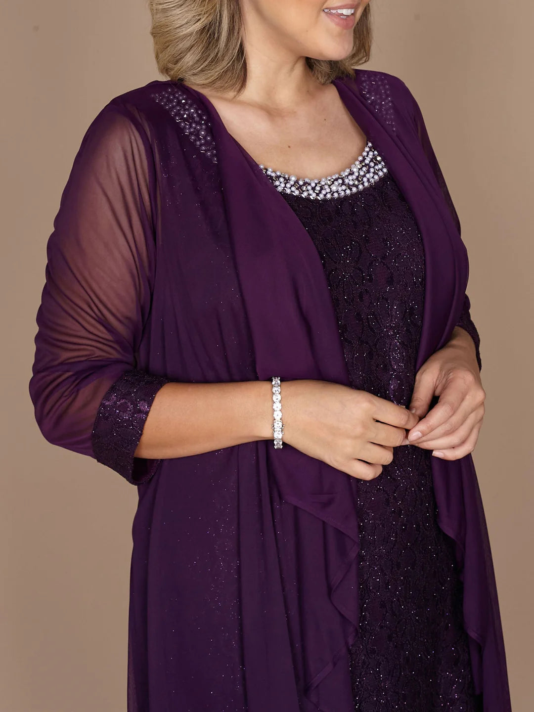 Detailed view of the lace neckline and short sleeves of the dress.