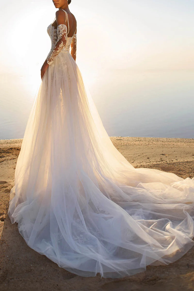 Side view of a bride wearing a sleeveless lace wedding dress.