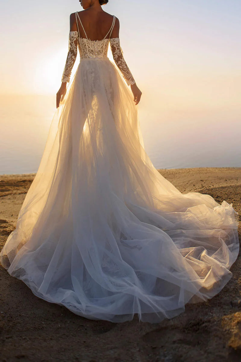 Close-up of the delicate lace fabric on the sleeveless wedding gown.