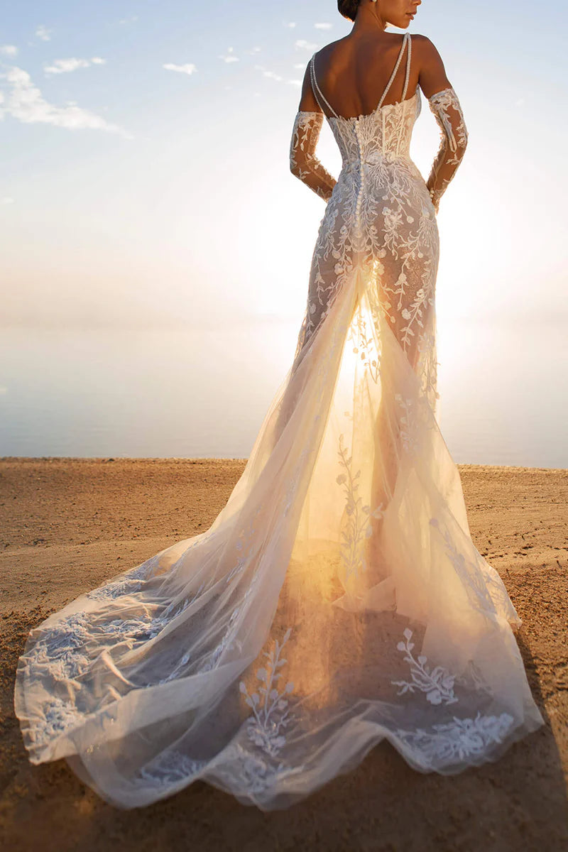 Bride posing in a sleeveless sheath wedding dress, showcasing its silhouette.