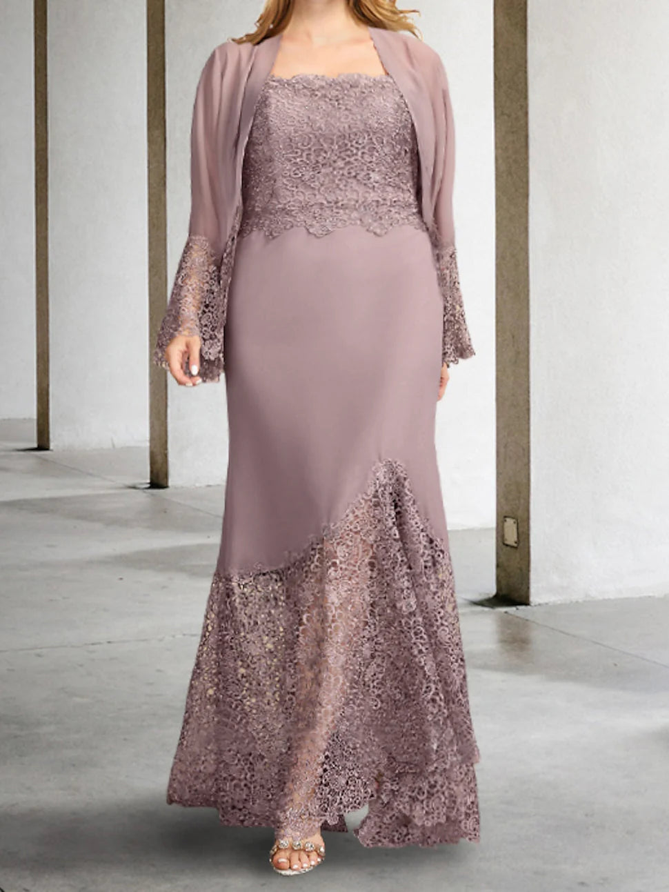 Woman wearing an elegant sleeveless sheath mother of the bride dress, ankle length.