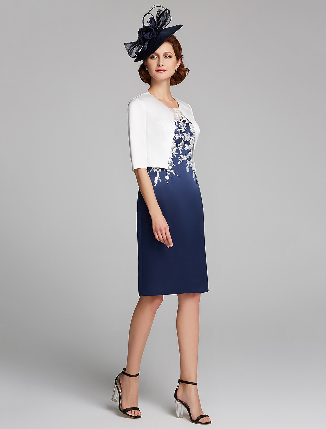 Woman wearing a knee-length sheath dress with a matching wrap.
