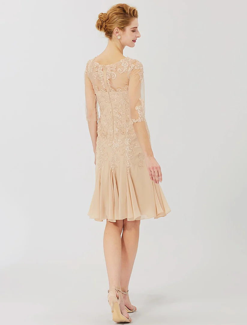 Back view of a woman in a chiffon and lace sheath dress, showing the illusion neckline.