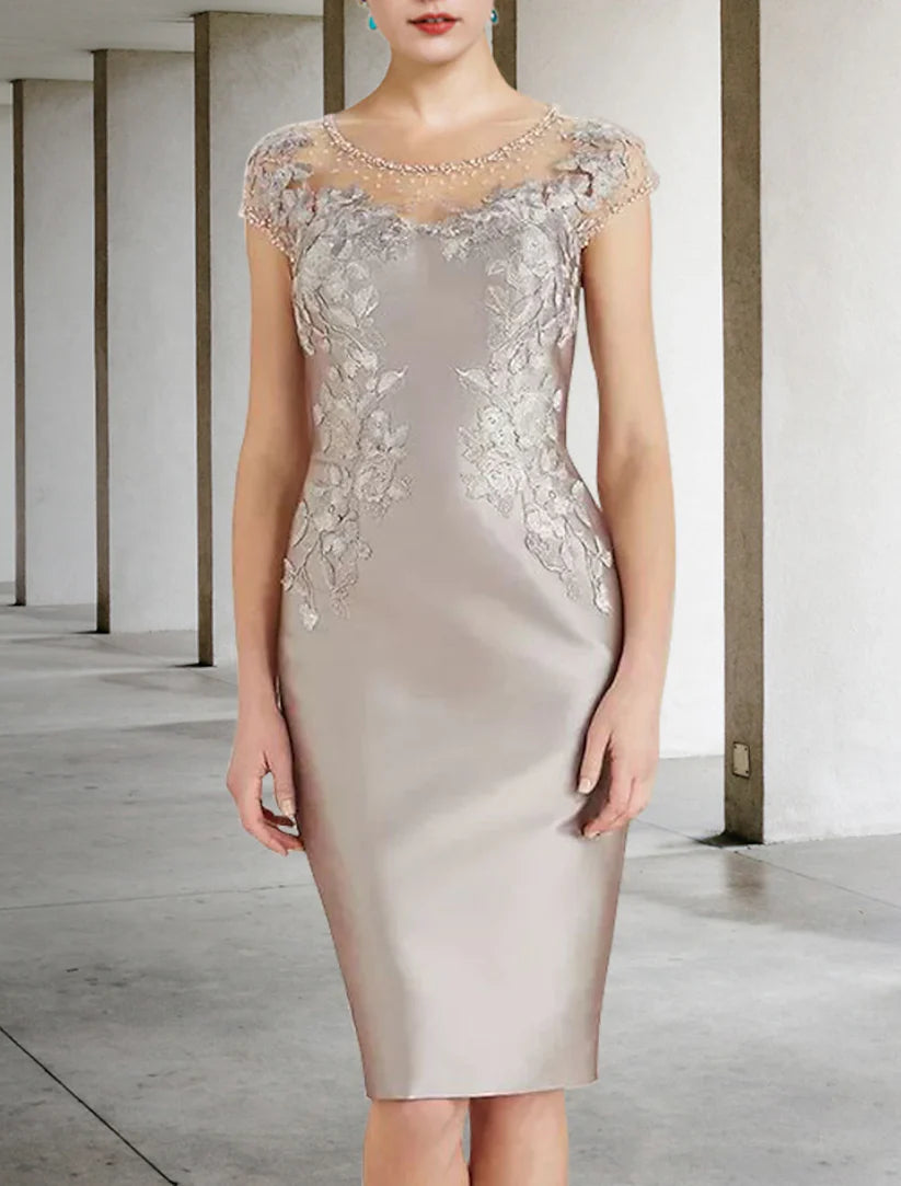 Close-up of the knee-length charmeuse dress, showcasing intricate beading appliques.