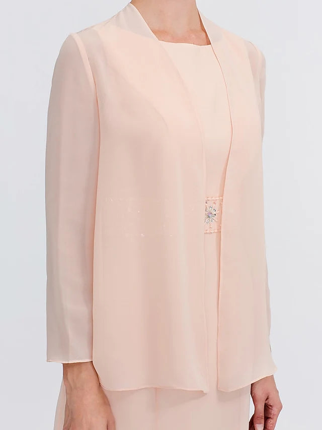 Side profile of an ankle-length sheath dress with delicate appliques.
