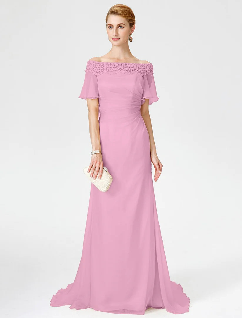 Side view of the pleated sheath dress, showing the flowing chiffon fabric.