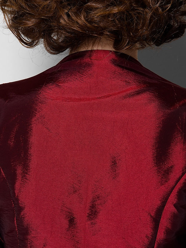 Scoop neck and 3/4 sleeve detail on the taffeta dress.