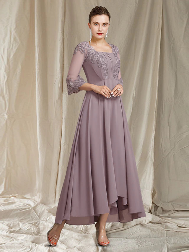 Back view of the elegant mother of the bride dress, showcasing the asymmetrical hem and delicate lace appliques.