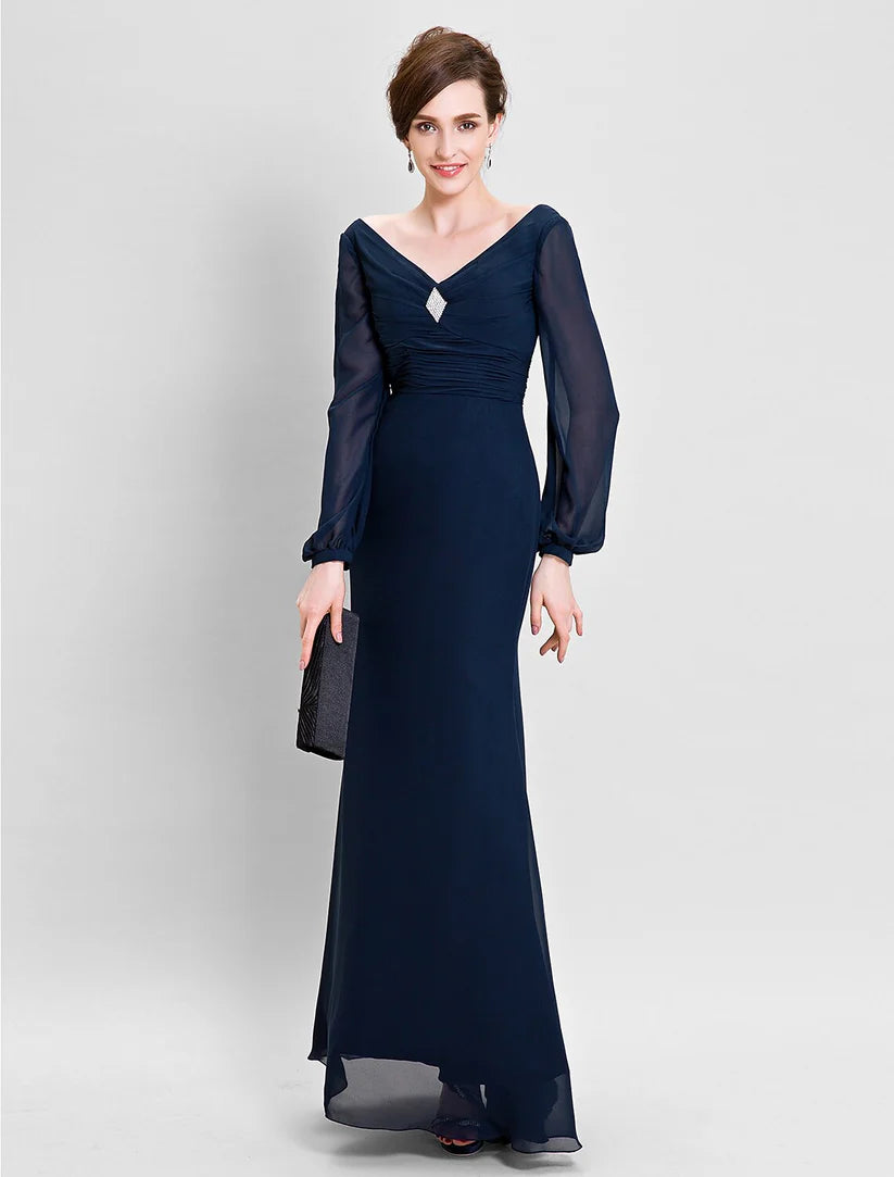 Woman wearing an elegant floor-length sheath Mother of the Bride dress with V-neck, long sleeves, and ruched chiffon.