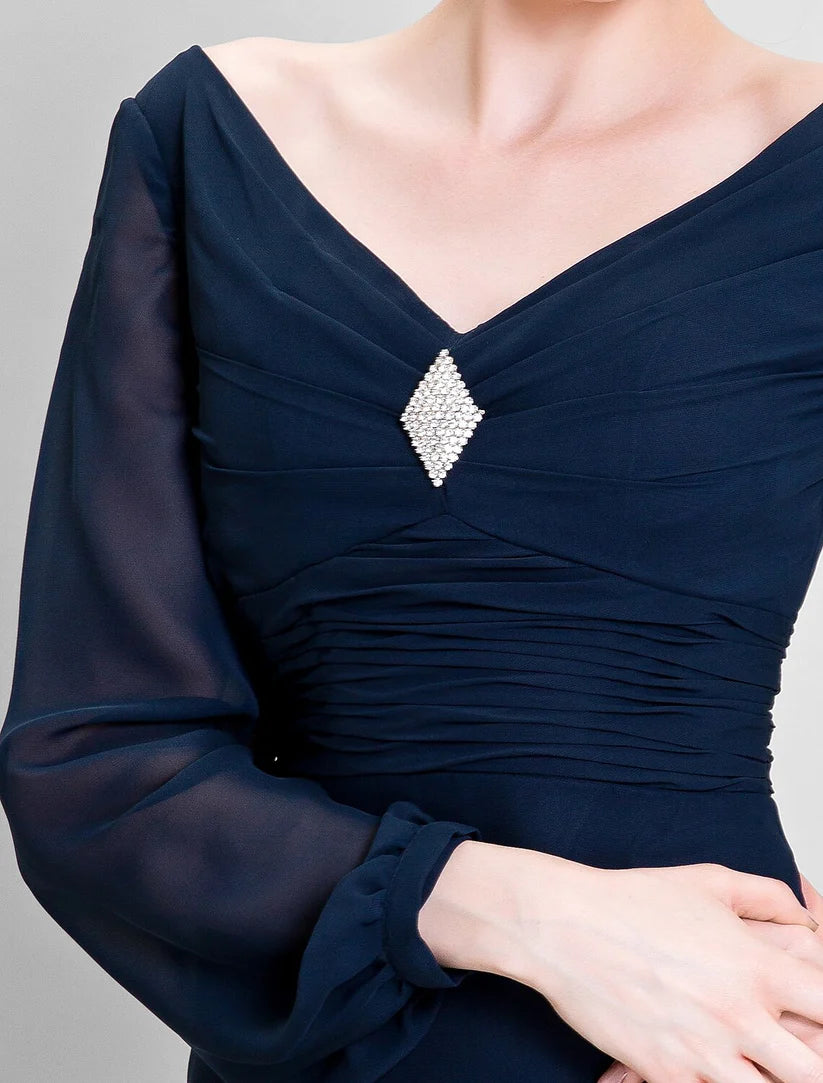 Side profile of the woman in the sheath Mother of the Bride dress, highlighting the ruched draping and silhouette.