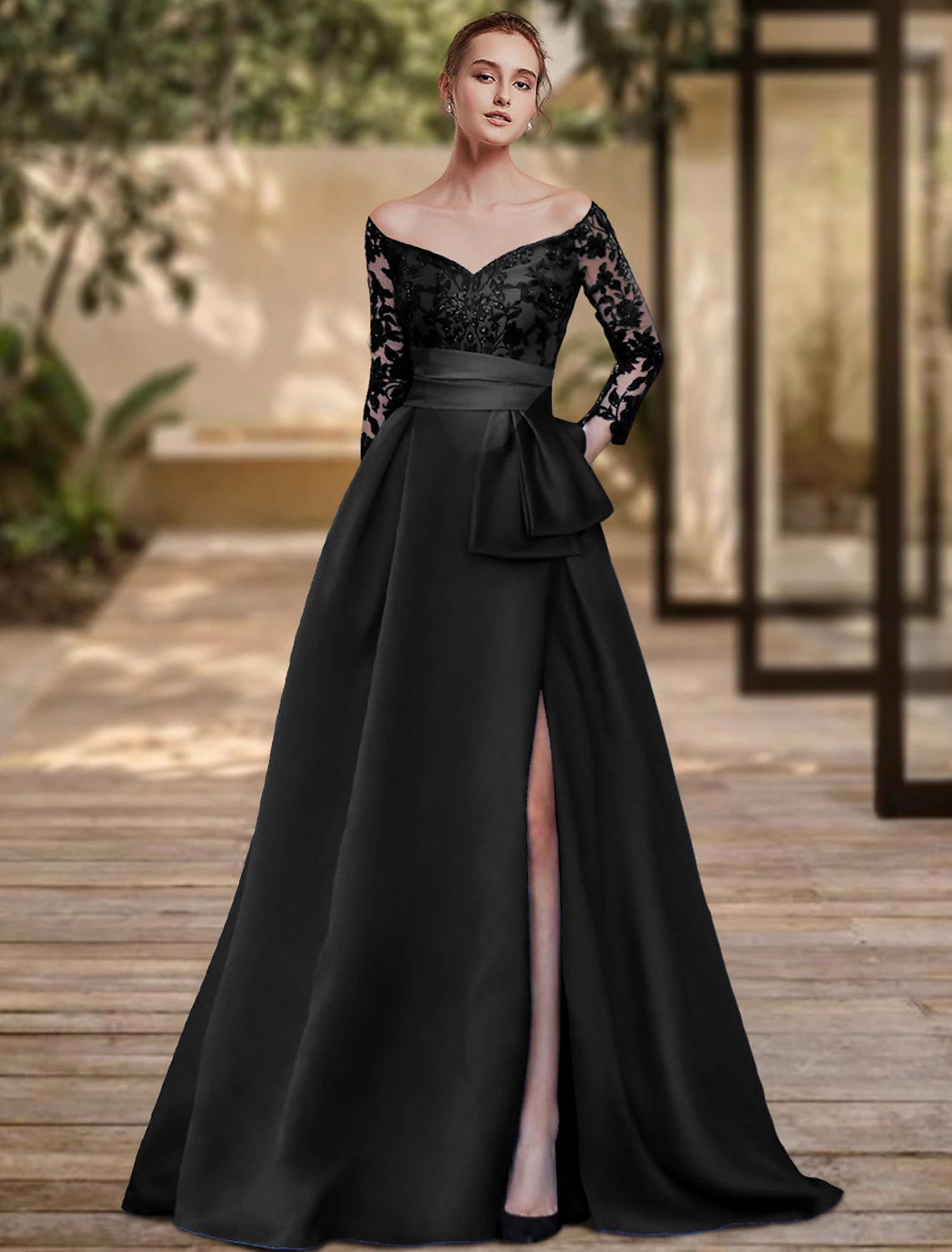 Back view of the sheath evening gown, showing the sweep train and bow detail.