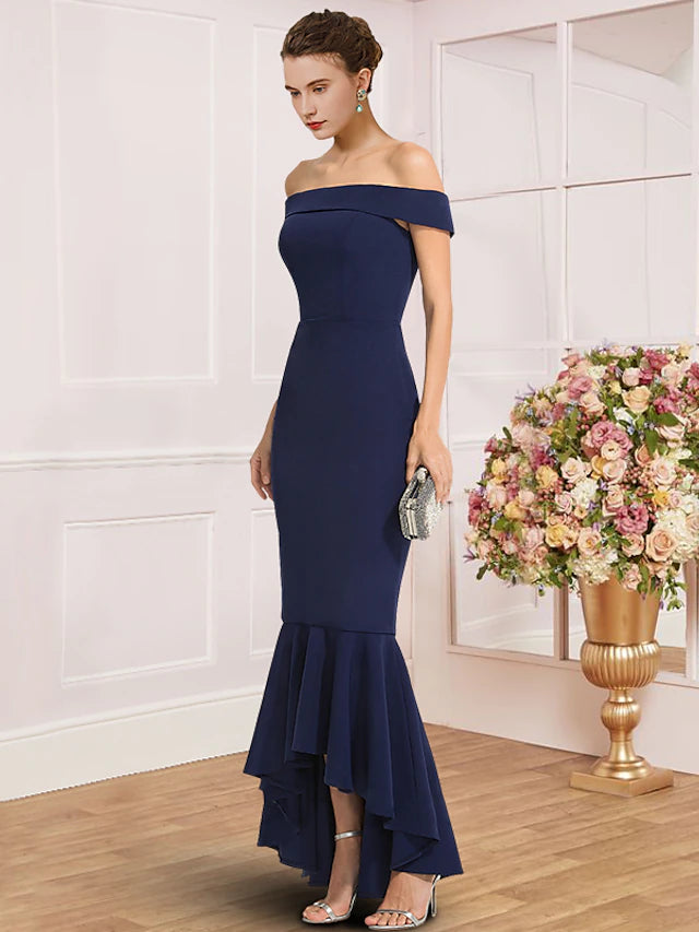 Side view of the asymmetrical sheath dress in stretch fabric.