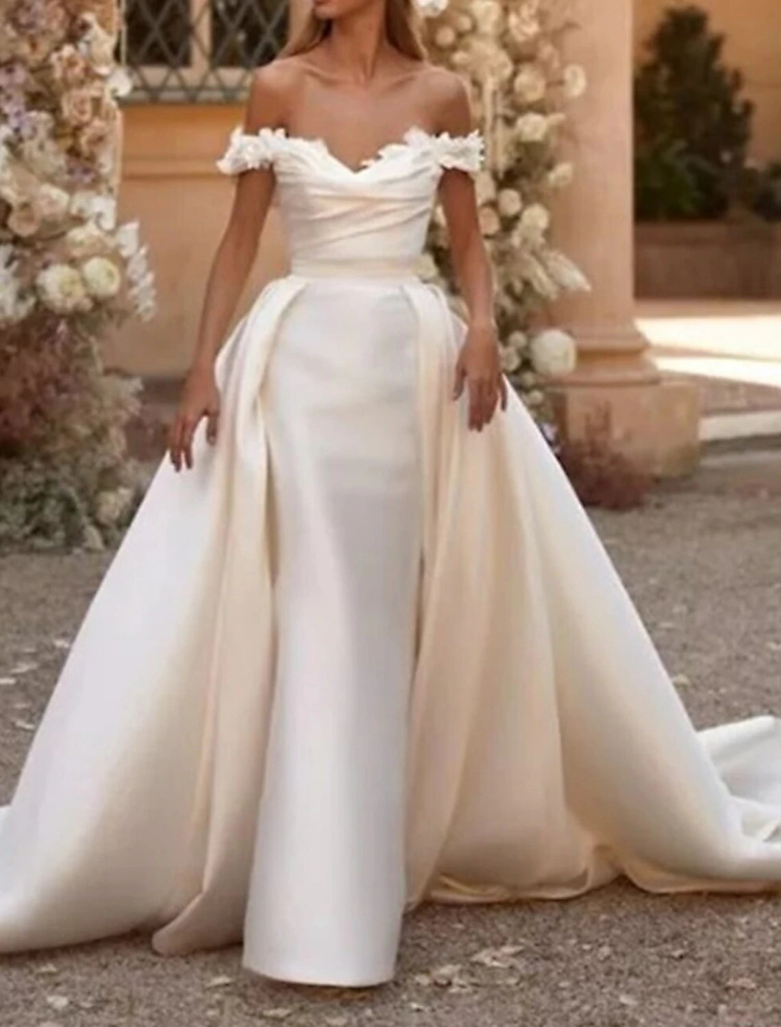 Elegant white sheath wedding dress with off-shoulder neckline and cap sleeves.