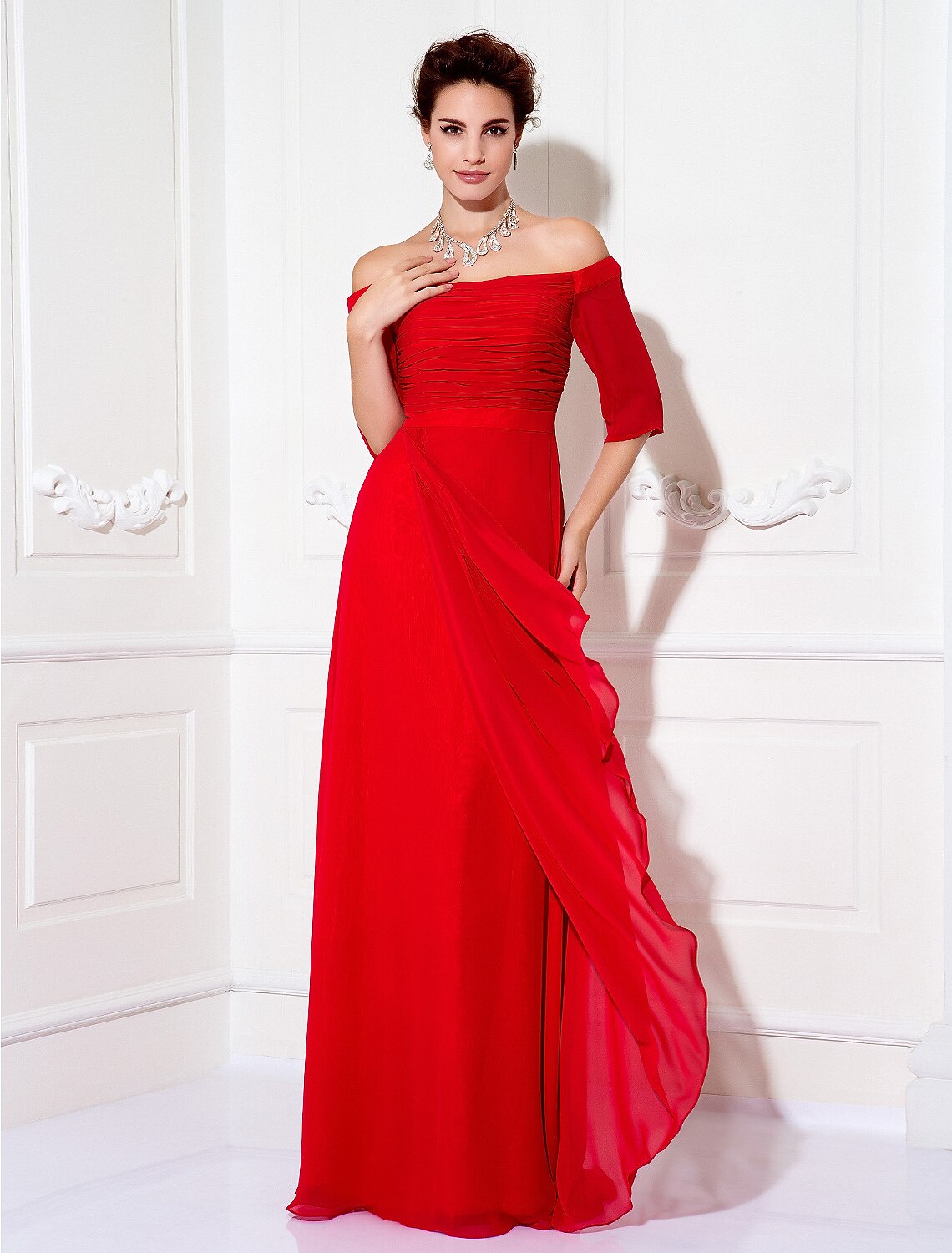 Model posing in the off-shoulder wedding guest dress, displaying the fabric flow.