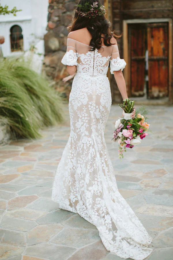 Romantic long wedding gown with half sleeves and lace details.