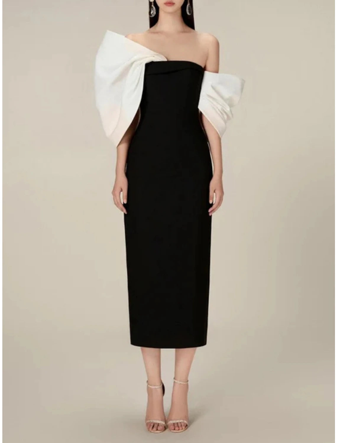 Woman posing in the elegant sheath gown, showing its graceful drape.