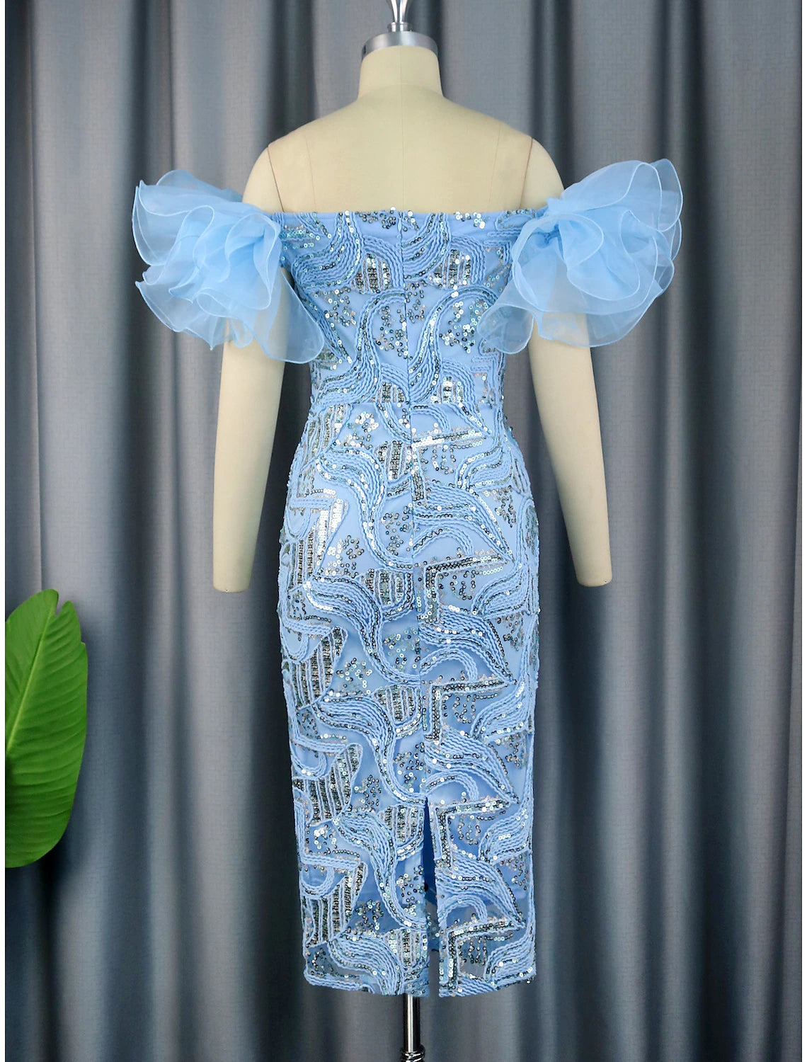Close-up of sequin and floral detail on the tea length dress.