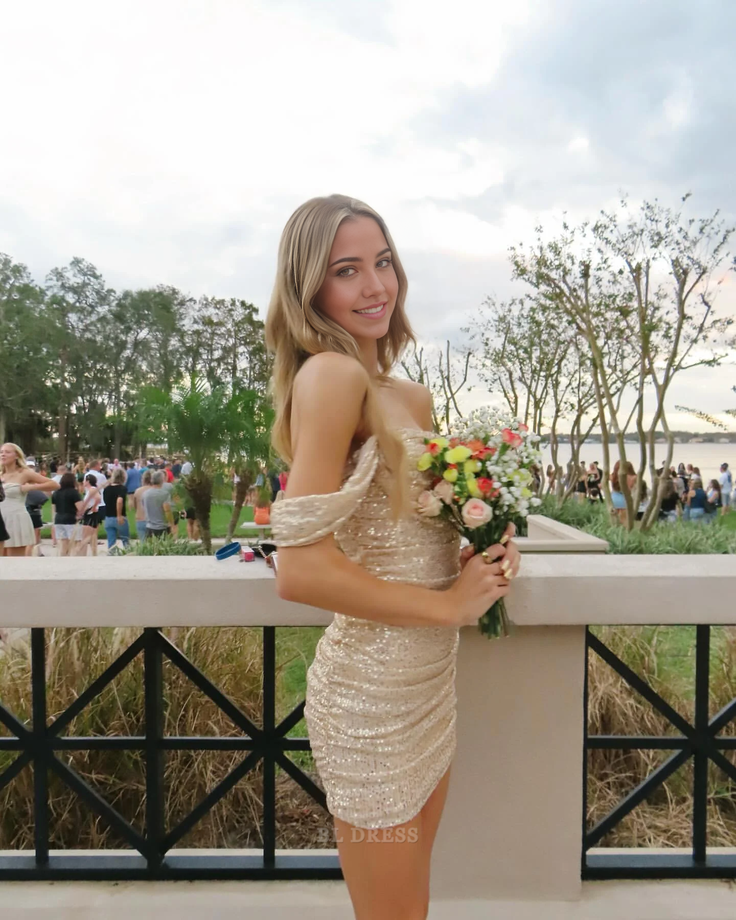 Model wearing an elegant off-shoulder short sheath dress, front view.