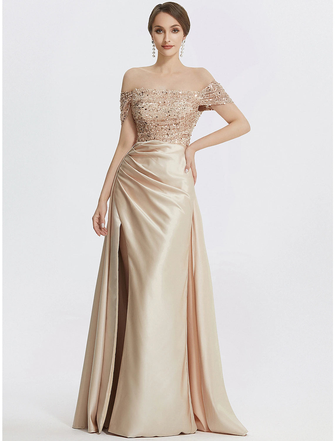 Woman in a navy blue sequined off-shoulder sheath evening gown with a high slit.