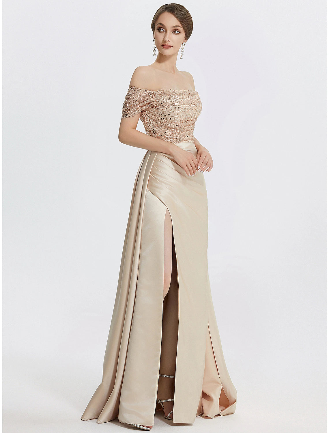 Back view of a woman in a shimmering navy blue sequined formal dress.