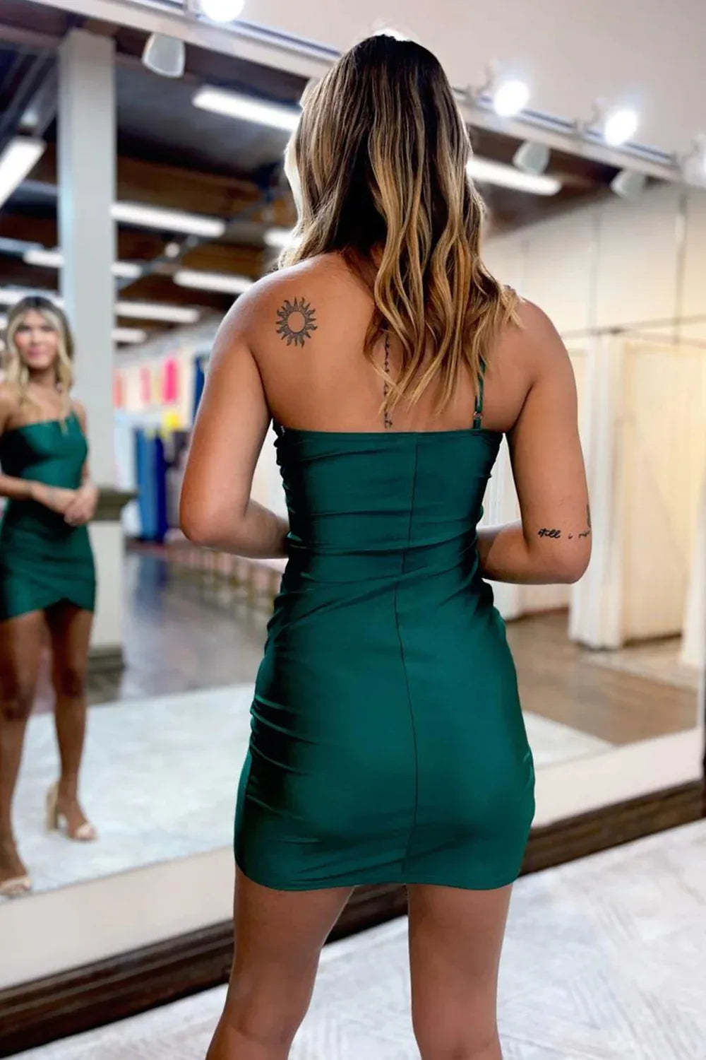Back view of a model in a one-shoulder bodycon party dress.