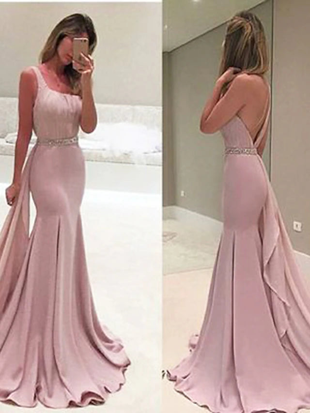 Elegant one-shoulder sheath evening gown in chiffon with ruched details and sweep train.