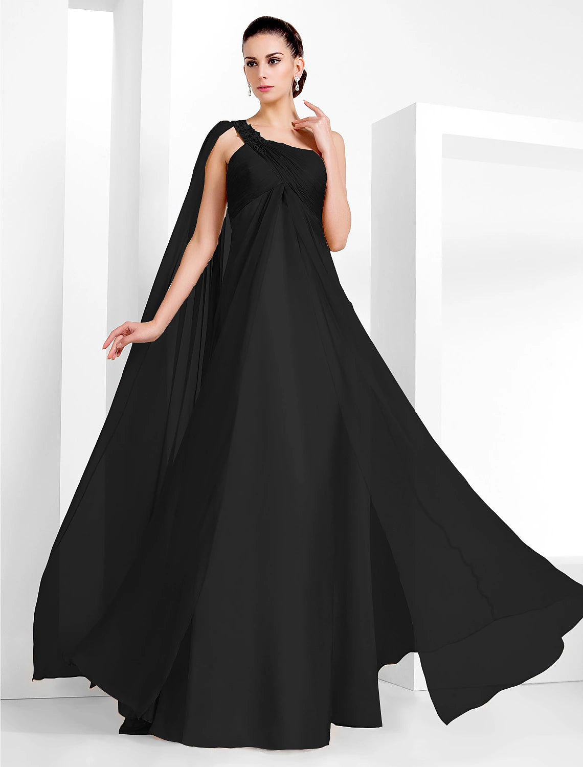 Side view of a woman wearing a black floor-length formal dress.