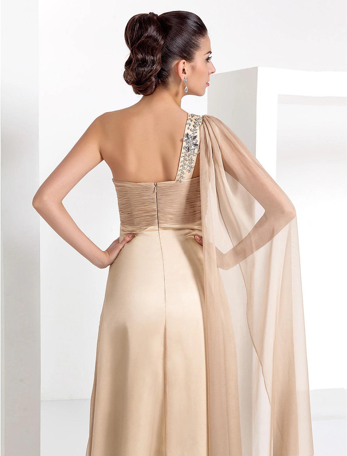 Woman showcasing the flowing chiffon fabric of the black formal dress.