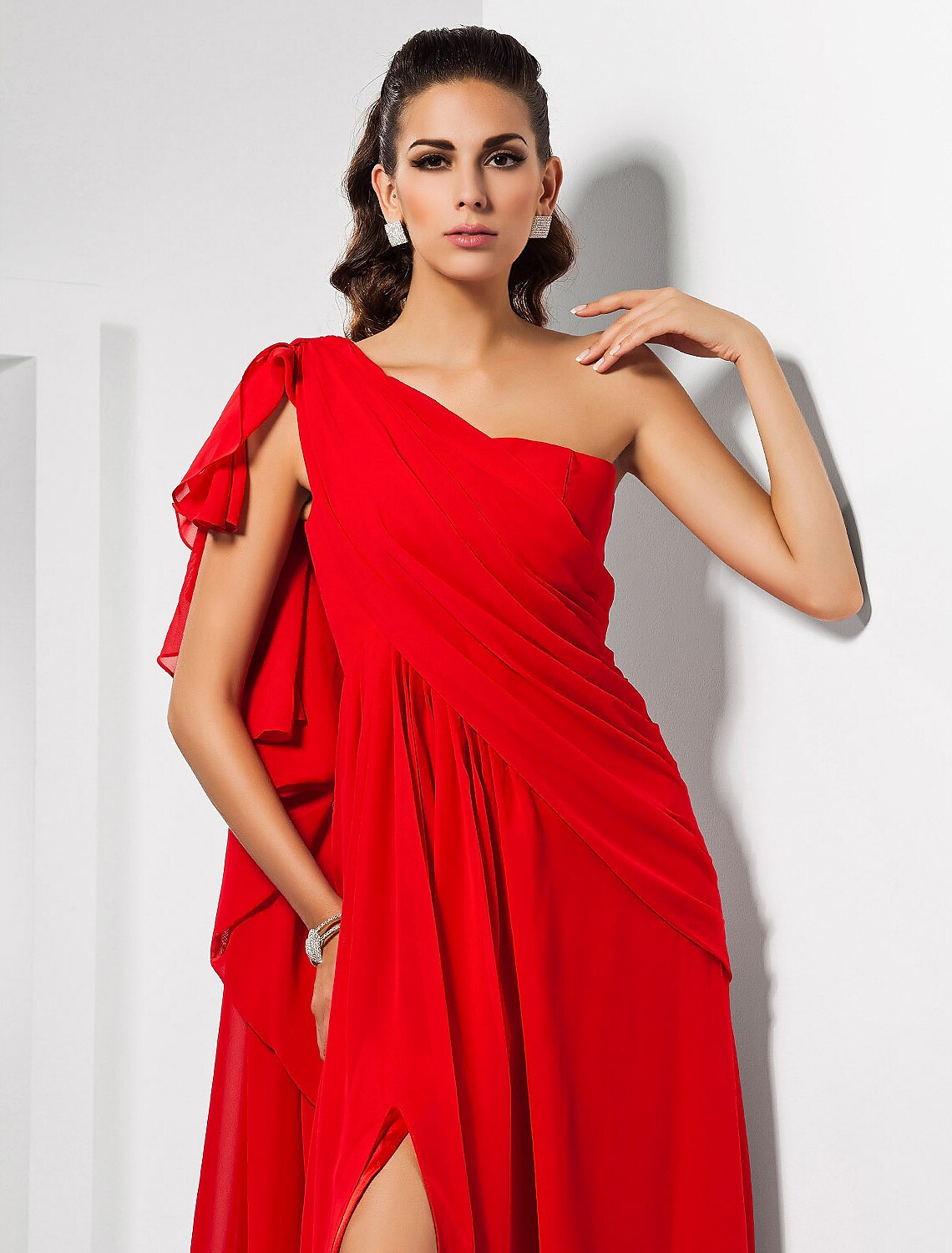 Side view of a red one-shoulder floor-length dress with draping.