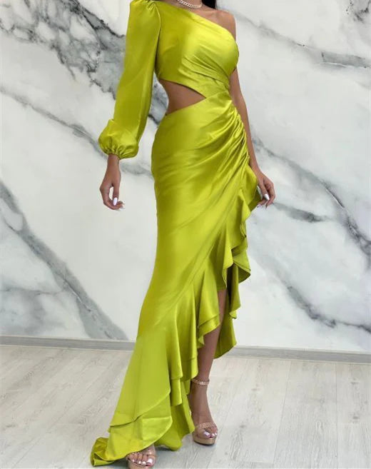 Elegant woman wearing a floor-length sheath one-shoulder prom dress in a formal setting.