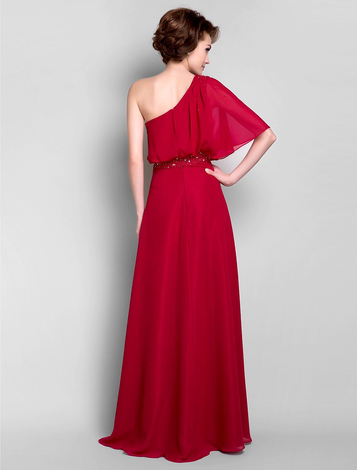 Side profile of the one-shoulder chiffon gown, highlighting the elegant silhouette.