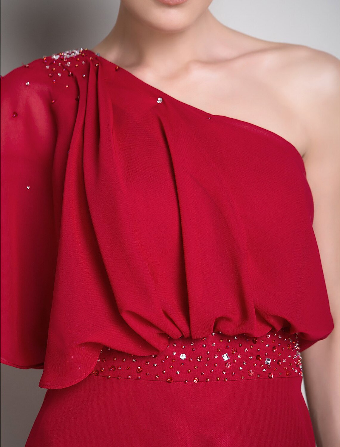 Detail of the half sleeve and one-shoulder neckline on the chiffon Mother of the Bride dress.