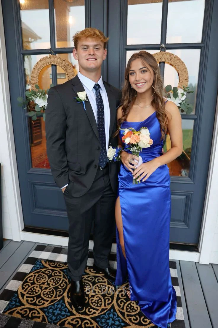 Model wearing an elegant royal blue one-shoulder sheath gown.