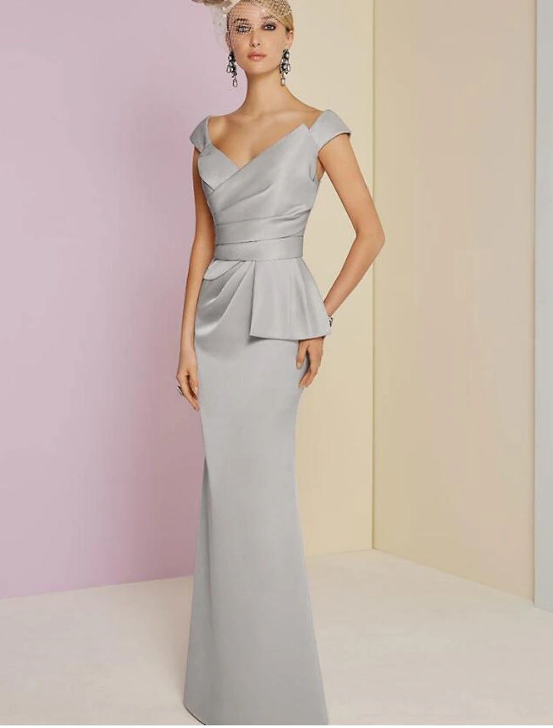 Elegant floor-length sheath evening gown with plunging neckline and ruched satin fabric.
