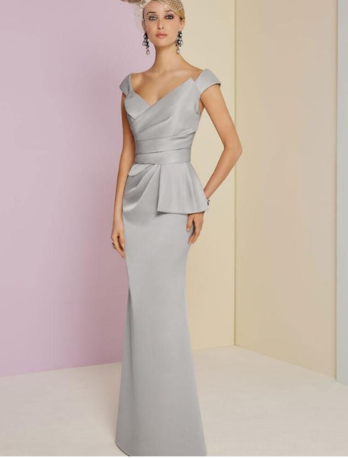 Elegant floor-length satin sheath gown with a plunging neckline and ruched details.