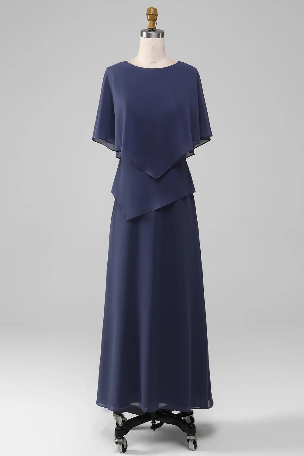 Woman in elegant stormy blue sheath tea-length chiffon dress, front view.