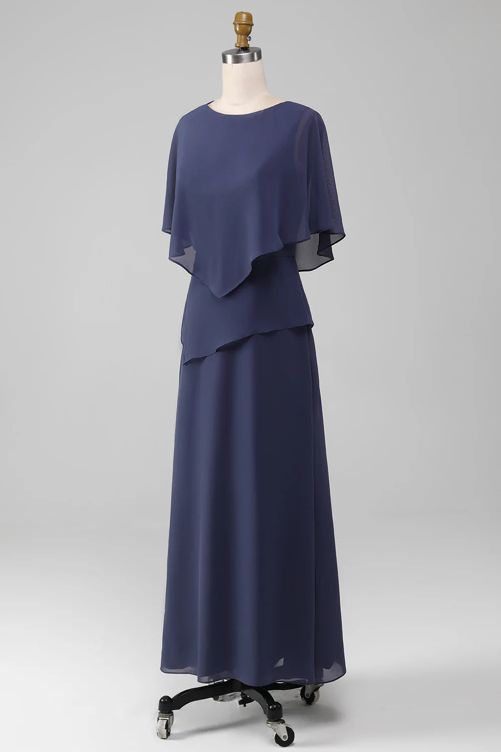 Woman in stormy blue sheath tea-length chiffon dress, back view.
