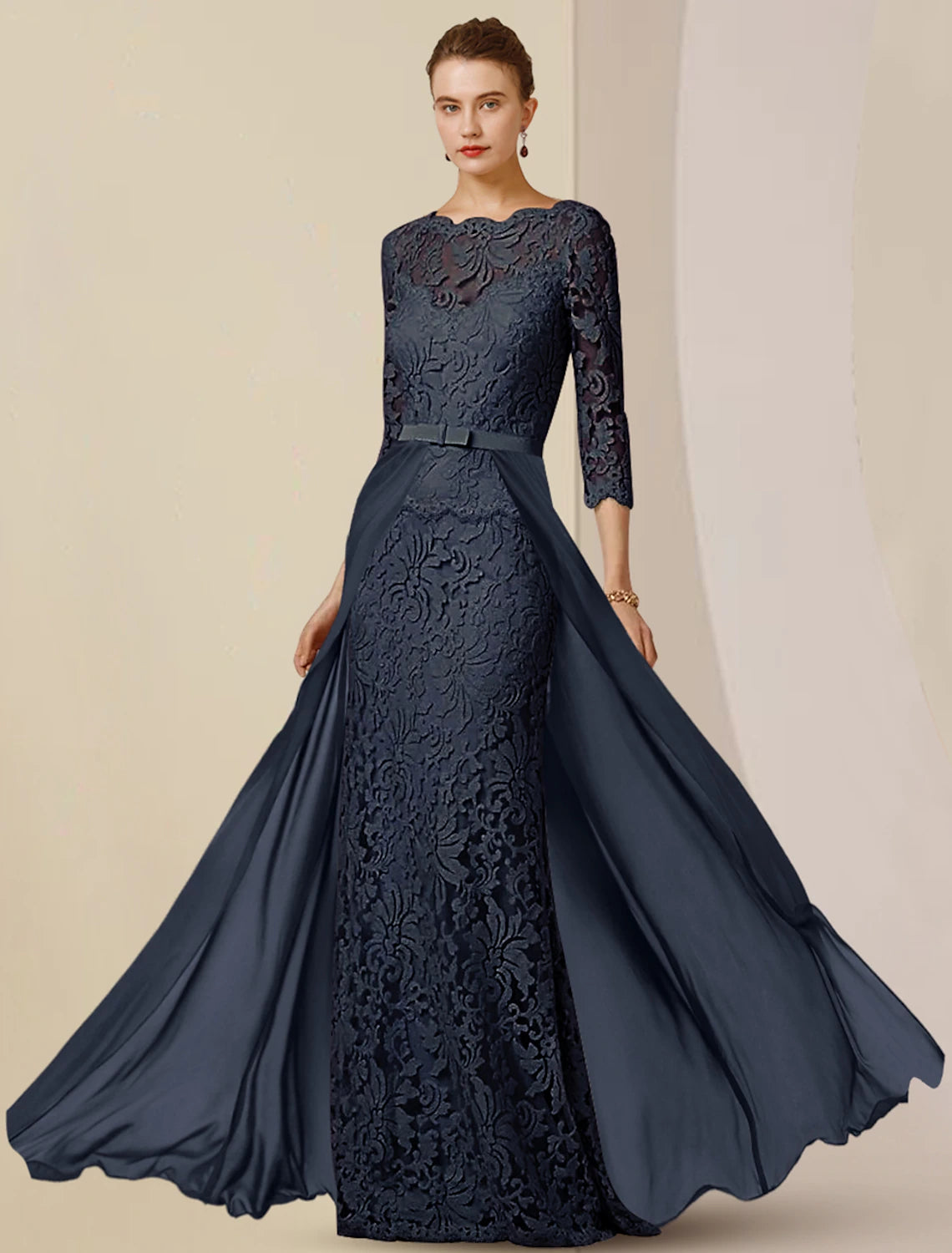 Back view of a floor-length chiffon lace gown with bow appliques.