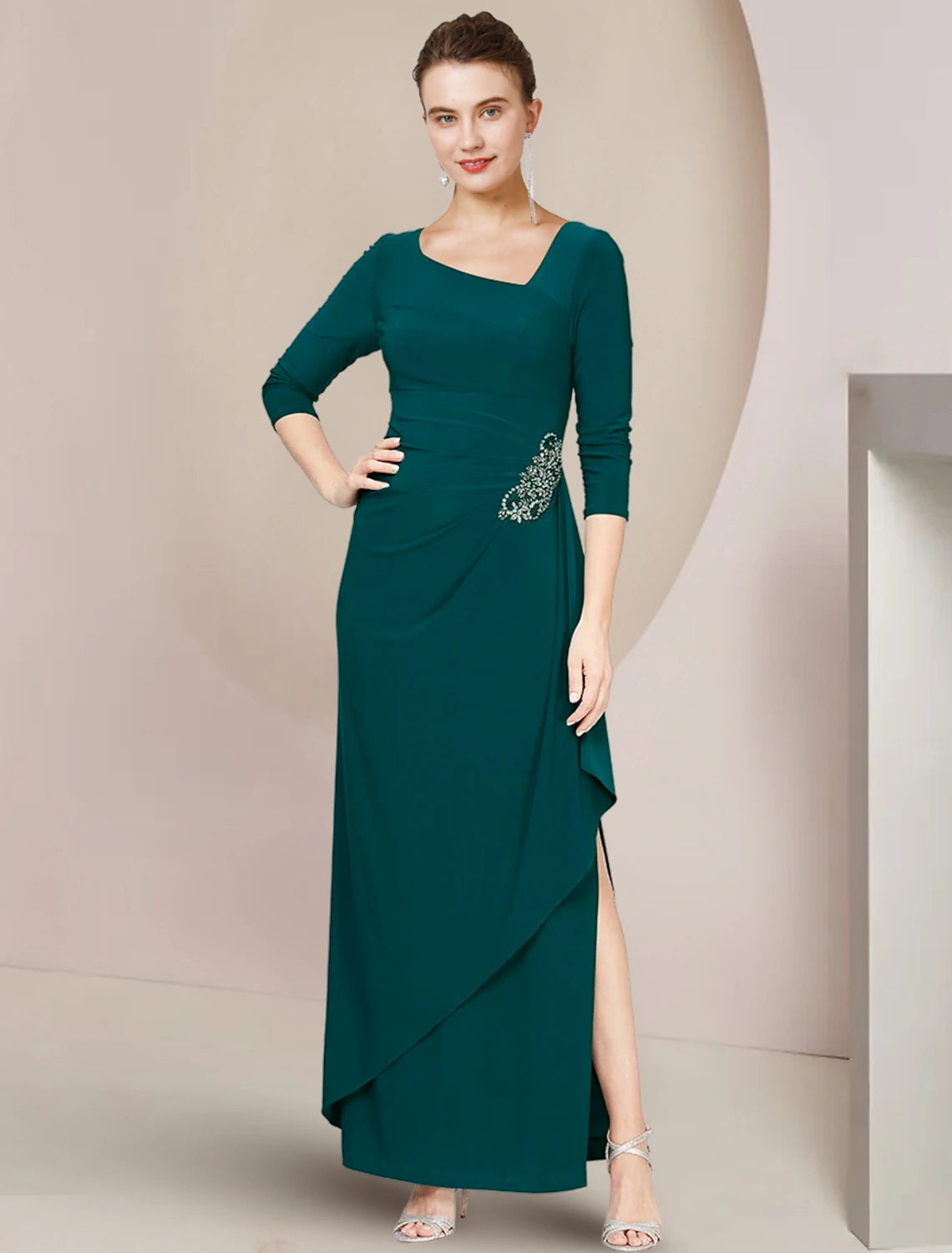 Side profile of a woman in a crystal-embellished mother of the bride dress, showing the ruffled details.