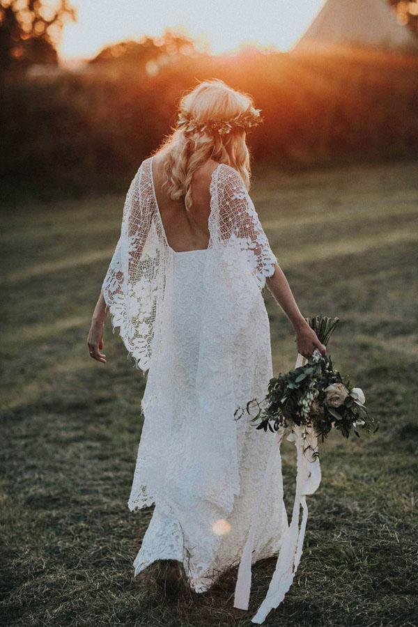 Back view of a sheath wedding dress showing the scoop back and split wraps.