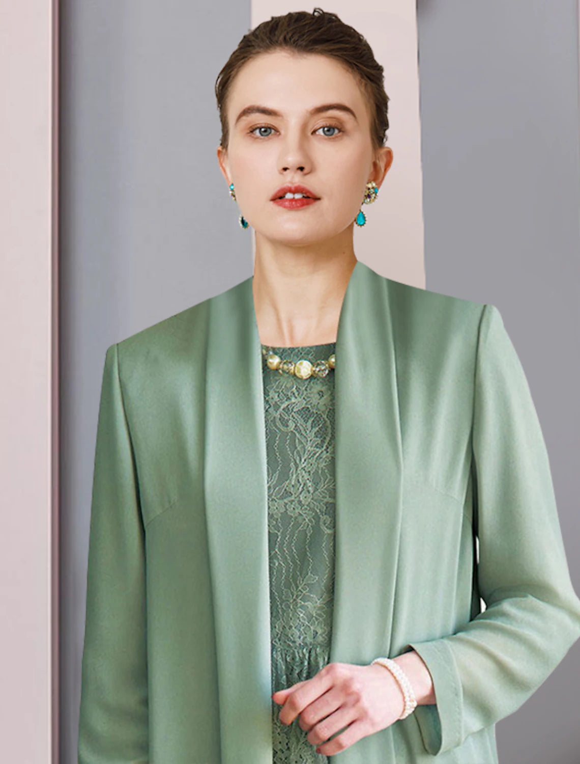 Sophisticated two-piece formal dress with a lace jacket and tea length chiffon skirt, suitable for wedding guests.