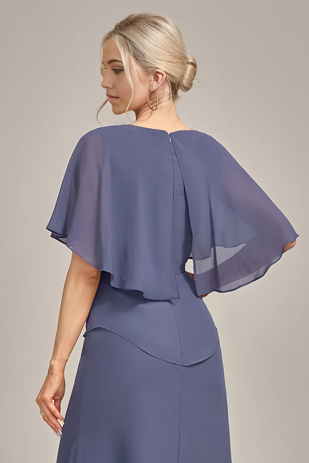 Woman posing in a tea-length sheath dress, showing movement.