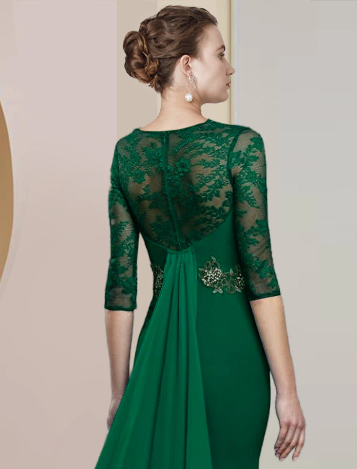 Close-up of appliques and lace on a half-sleeve formal dress.