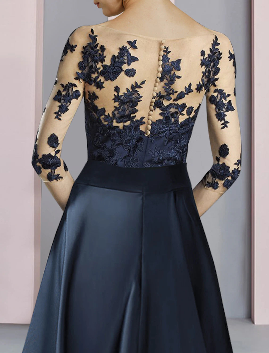 Close-up of the lace half sleeve and bow detail on the elegant dress.